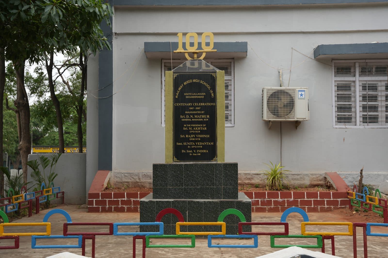 The centenary monument marking one hundred years of the school, set in a planted bed