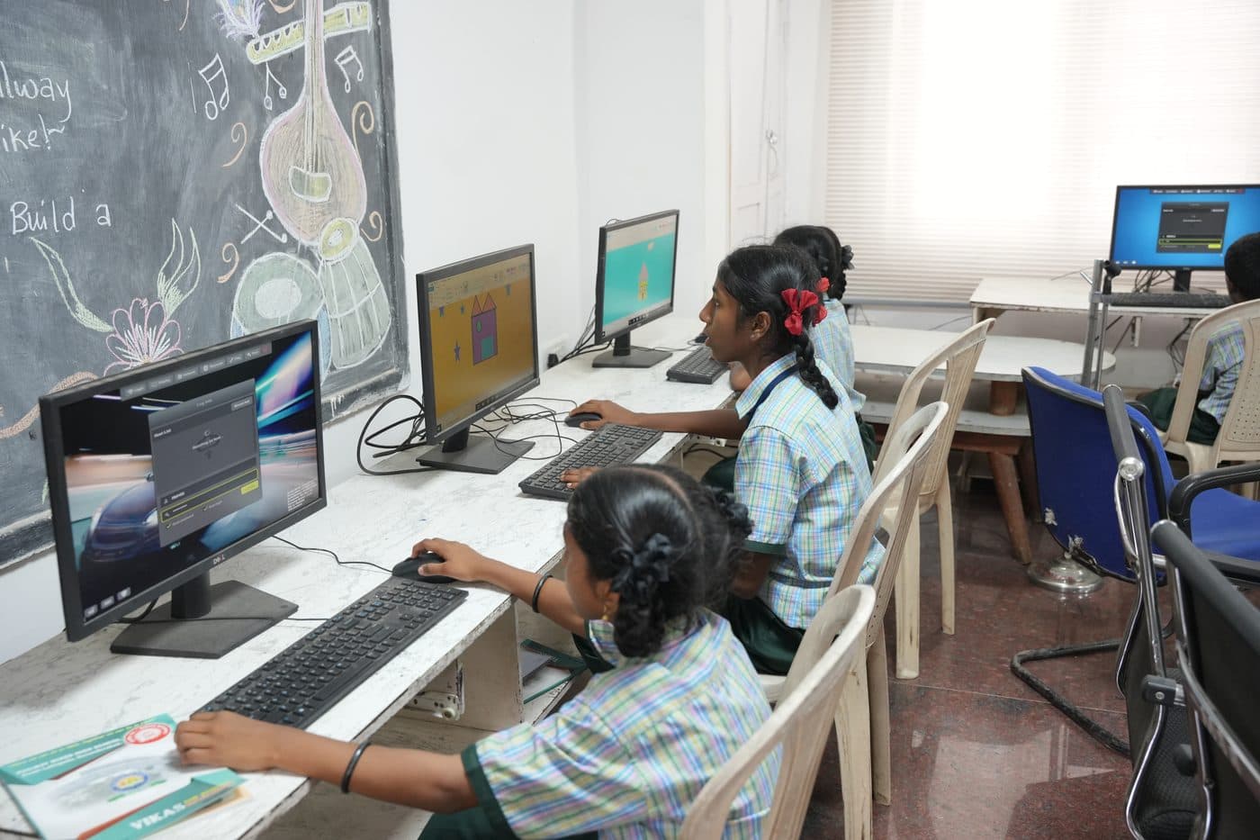 A student working at a computer with the monitor and keyboard in close view