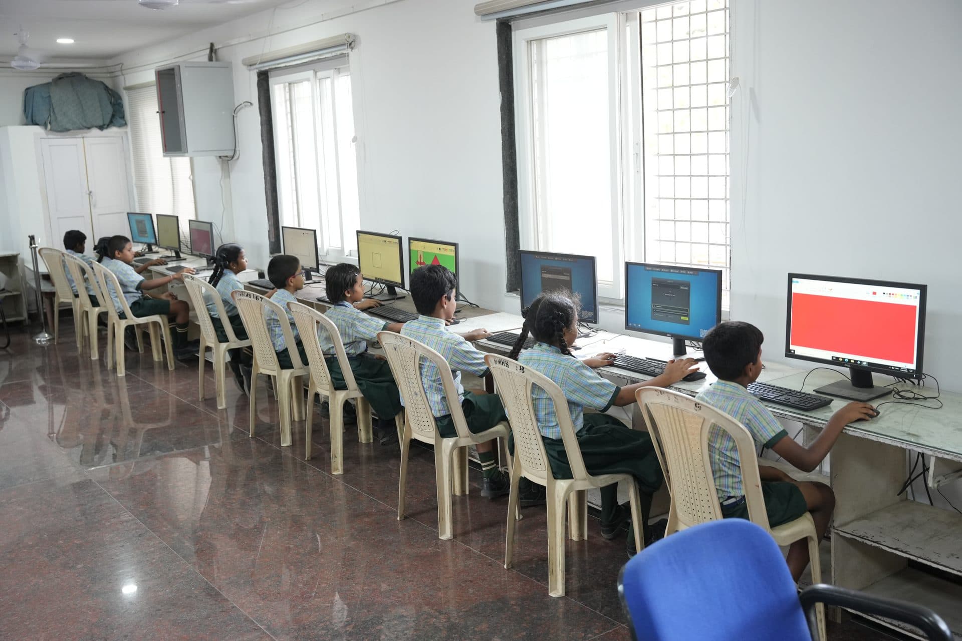 The computer laboratory with two long rows of students working at desktop machines