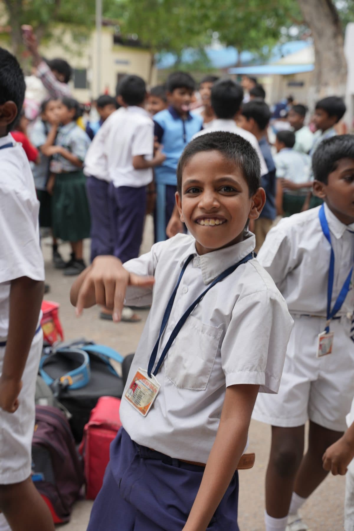 A smiling student in school uniform during a campus event