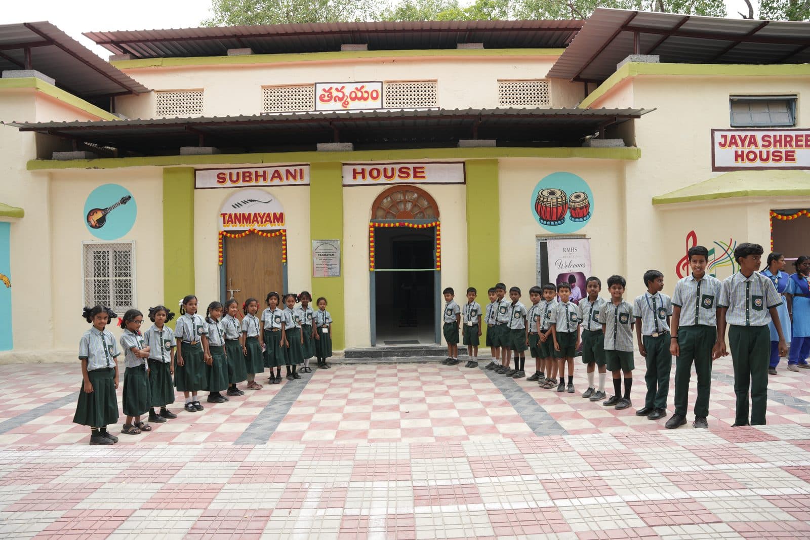 Students lined up in the courtyard outside the Tanmayam block before a programme