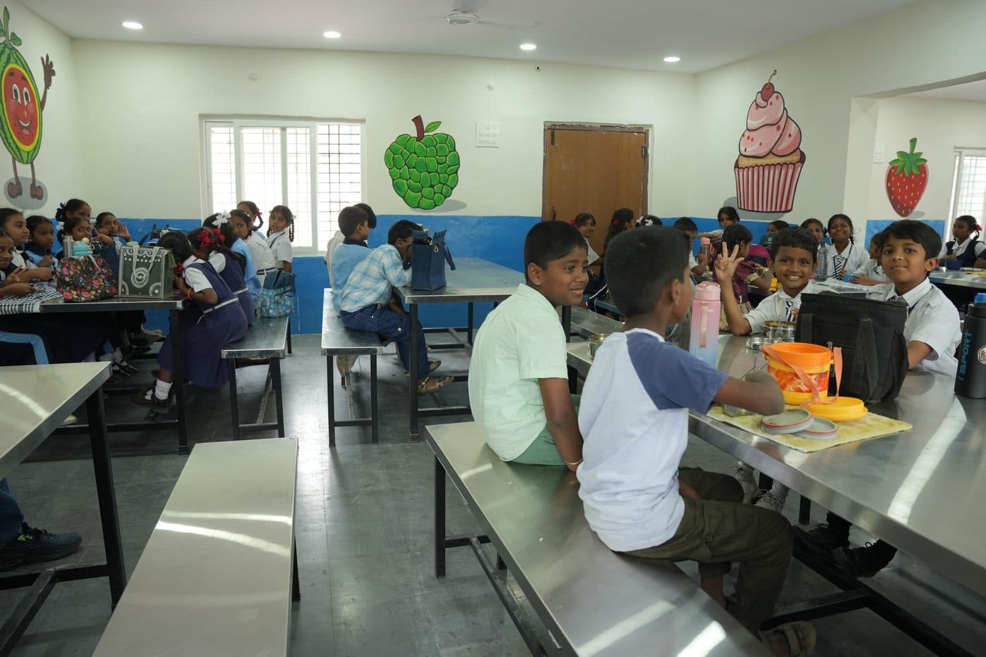 Two students sharing a meal across the dining table in the Tripti hall